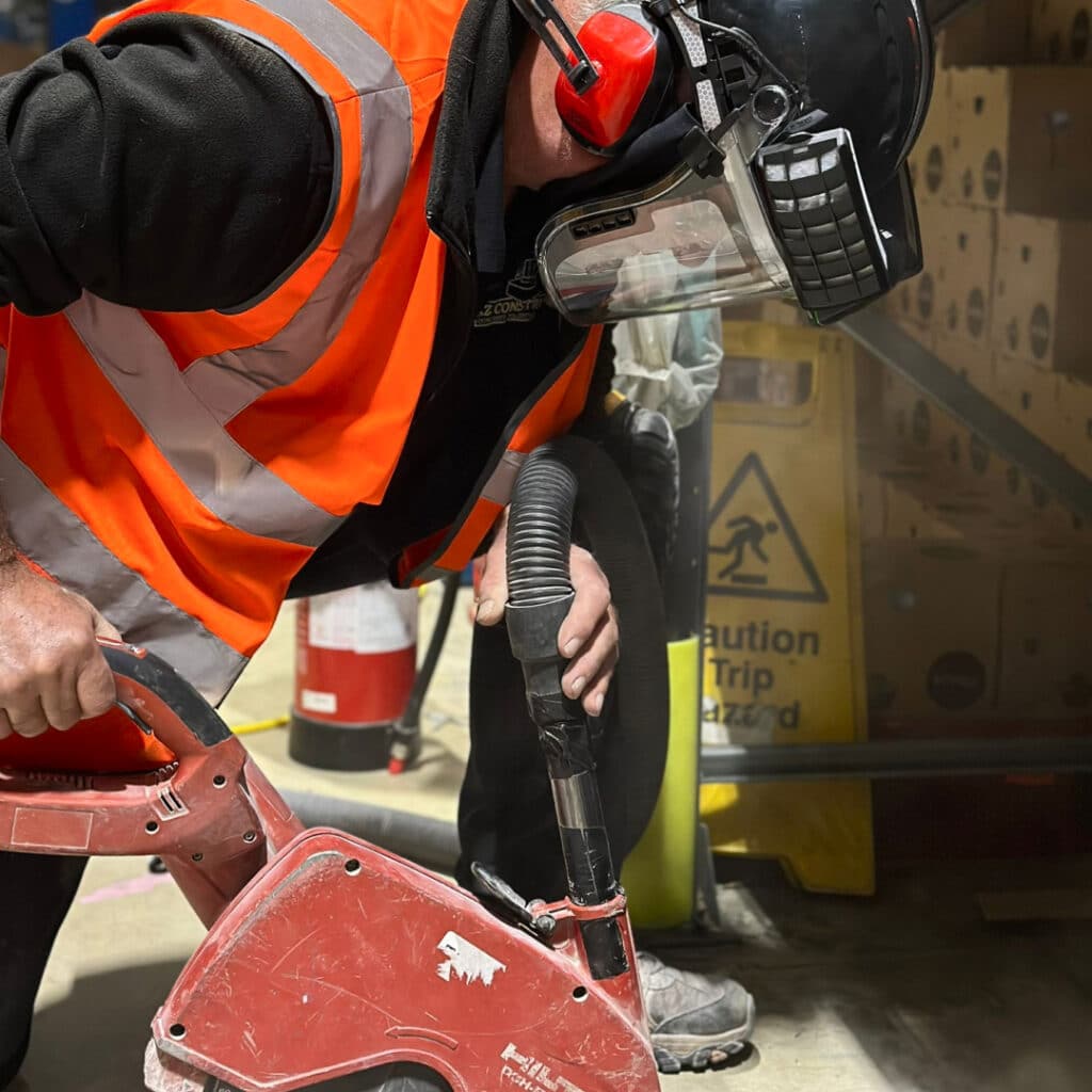 man fixing crack on warehouse floor