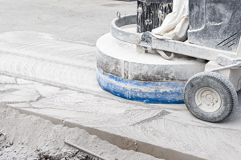 Photo of a concrete grinding machine in use on a concrete road