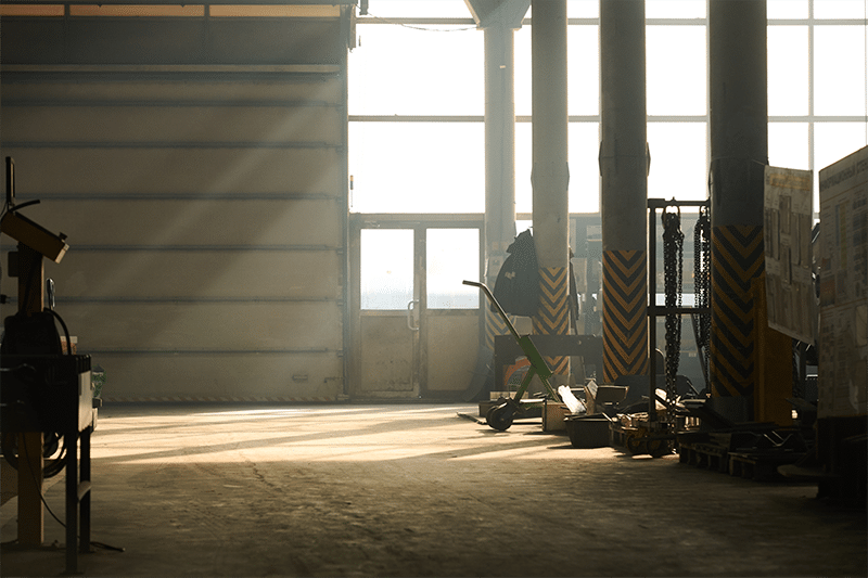 A photo of a workshop interior where light is shining through dusty air.
