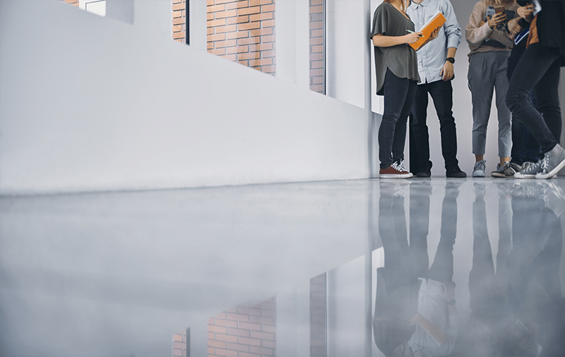 A floor-level shot of a polished concrete floor in a student hall.