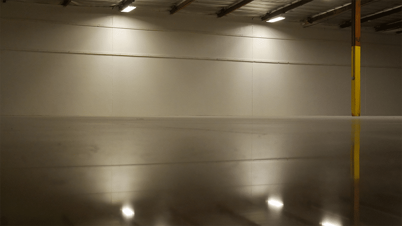 Photo of a polished concrete floor reflecting the ceiling lighting.