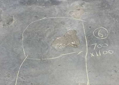 Photo of the delaminated floor at the Tesla Garage which MKZ Construction repaired.